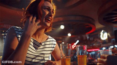 Woman Talking On Cell Phone At Bar GIF