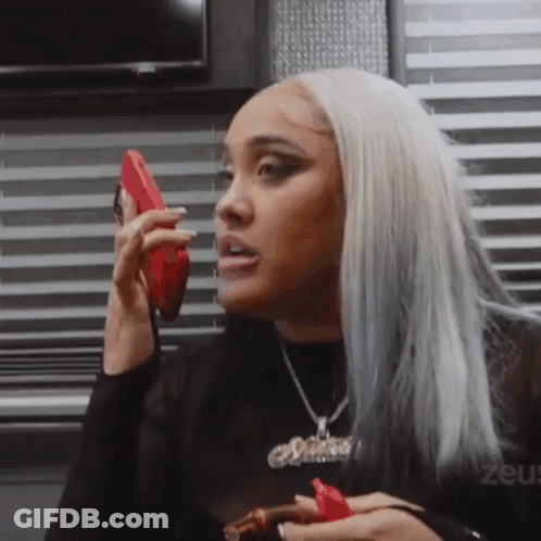 Woman Talking On Cell Phone Holding Cigar GIF