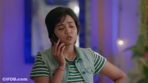 Woman Talking On Cell Phone In Striped Shirt And Denim Vest GIF