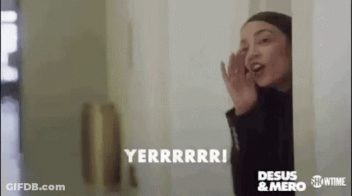 Woman Talking On Cell Phone Peeking Out Door GIF