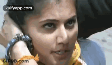 Woman Talking On Cell Phone While Man Holds Her Head GIF