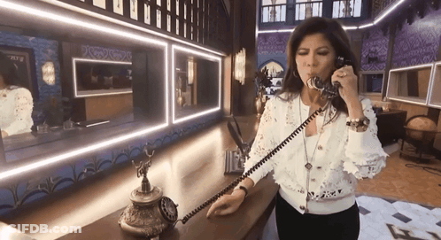 Woman Talking On Old-Fashioned Phone In Mirror GIF