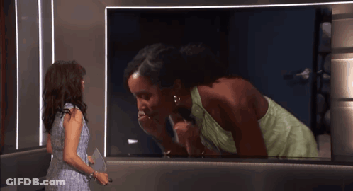 Woman Talking On Old Fashioned Telephone In Mirror GIF