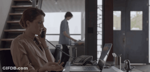Woman Talking On Phone At Desk GIF