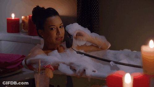 Woman Talking On Phone In Bathtub With Candles GIF