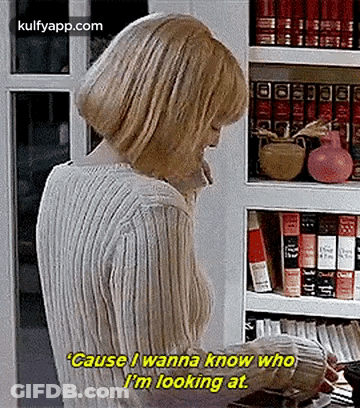 Woman Talking On Phone In Front Of Bookshelf GIF