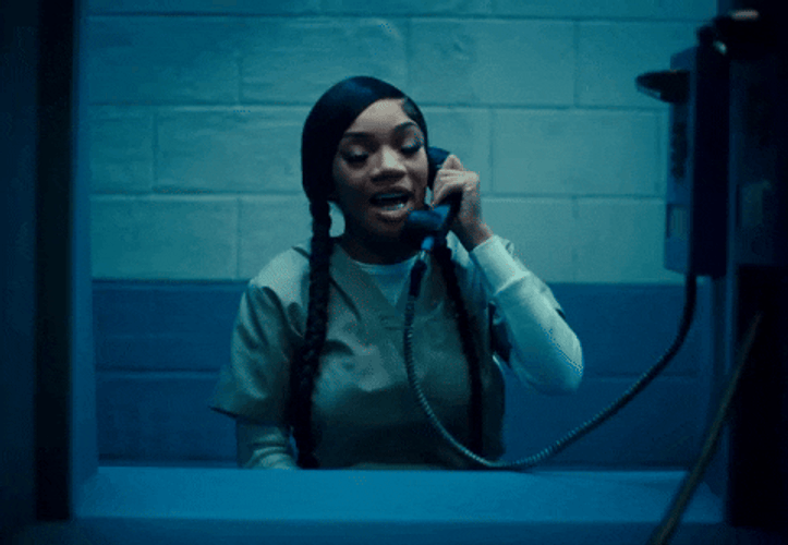 Woman Talking On Phone In Prison GIF