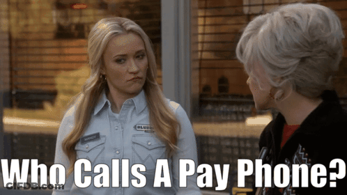 Woman Talking To Another Woman Saying Who Calls A Pay Phone GIF