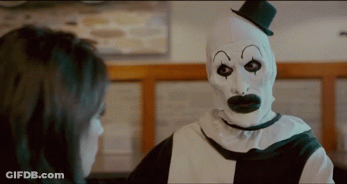 Woman Talking To Clown In Top Hat GIF