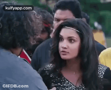 Woman Talking To Man In Crowd GIF