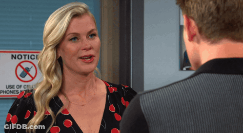 Woman Talking To Man In Front Of Notice Sign GIF