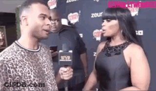 Woman Talking To Man With Microphone GIF
