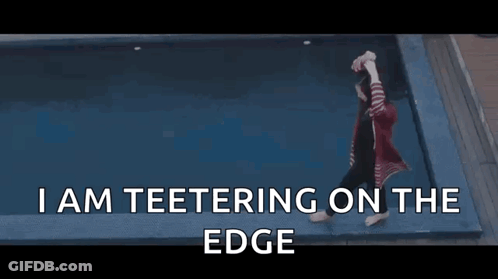 Woman Teetering On Edge Of Pool GIF