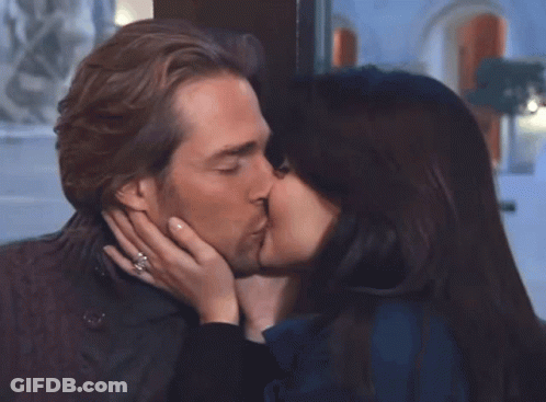 Woman Touches Man's Nose, Man Looks On GIF