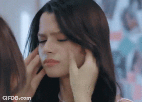 Woman Touching Another Woman's Face In Mirror GIF