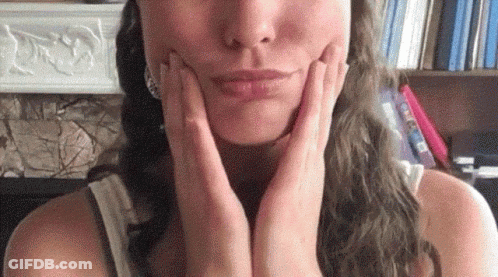 Woman Touching Her Face With Hands GIF