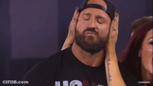 Woman Touching Man's Ear With Subscribe Tattoo GIF