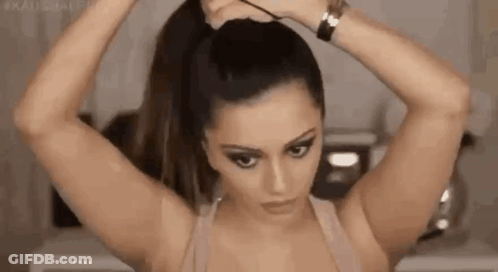 Woman Tying Hair In Ponytail With Rubber Band GIF