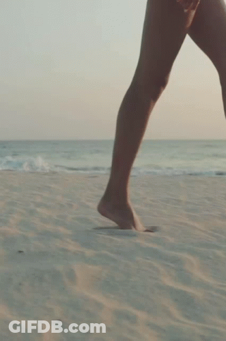 Woman Walking Barefoot On Beach GIF