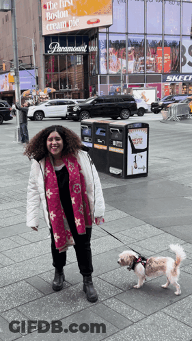 Woman Walking Dog In Front Of Paramount Sign GIF