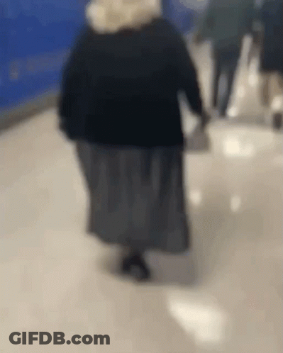 Woman Walking Down Hallway GIF