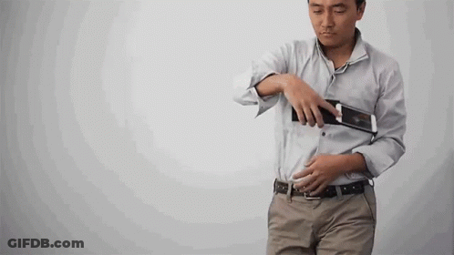 Woman Walking Down Hallway Holding Camera GIF