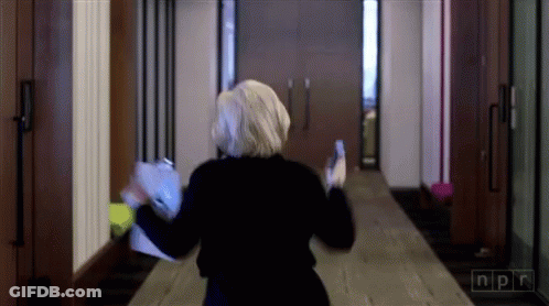 Woman Walking Down Hallway With NPR GIF