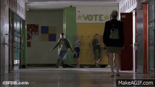Woman Walking Down Hallway With Vote Sign GIF