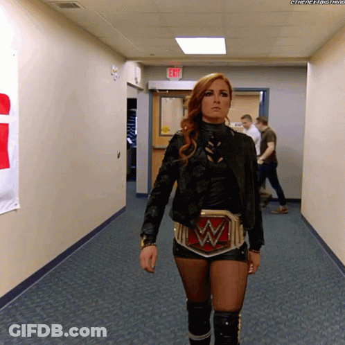 Woman Walking Down Hallway With W Belt GIF