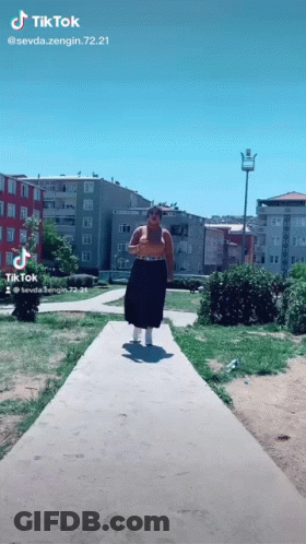 Woman Walking Down Path With TikTok Watermark GIF
