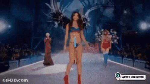 Woman Walking Down Runway At Fashion Show GIF