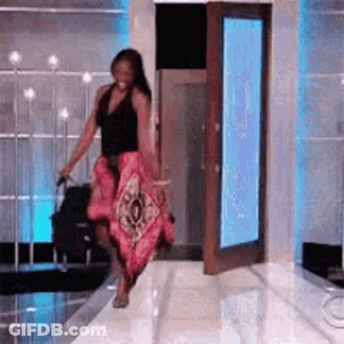Woman Walking Down Runway With Suitcase GIF