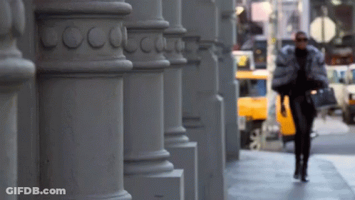 Woman Walking Down Sidewalk In Front Of Coco Chanel GIF