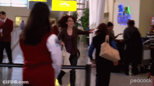 Woman Walking In Airport With Peacock GIF