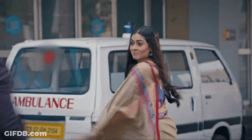 Woman Walking In Front Of Ambulance GIF