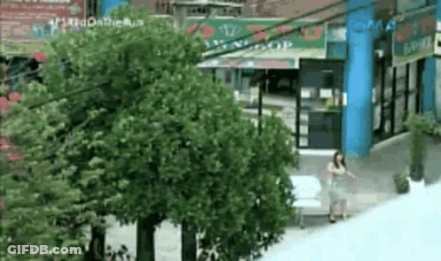 Woman Walking In Front Of Building With Smas Sign GIF
