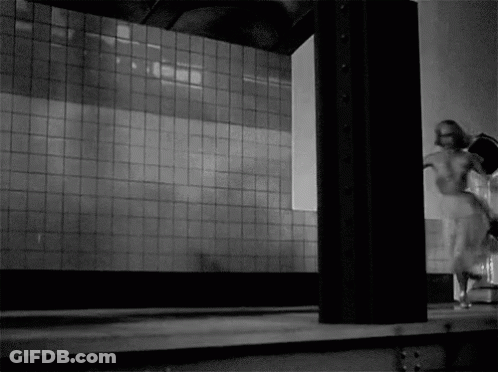 Woman Walking In Front Of Tiled Wall GIF