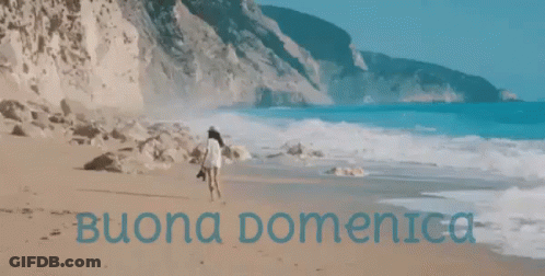 Woman Walking On Beach With Buona Domenica In Blue GIF