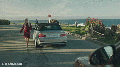 Woman Walking Towards Silver Car With License Plate EW2123 GIF