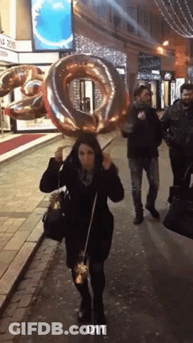 Woman Walking With Balloon Saying Dit GIF