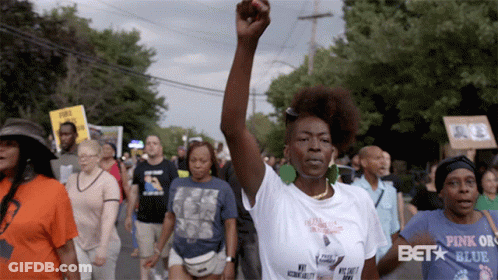 Woman Walking With Fist In Air GIF