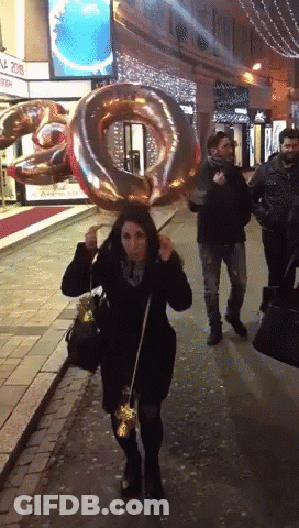 Woman Walking With Number 20 Balloon GIF