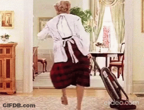Woman Walking With Vacuum Cleaner In Living Room GIF