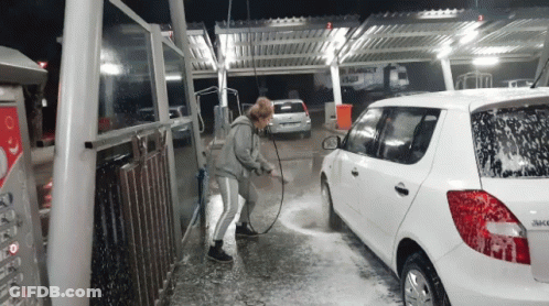 Woman Washing White Car With Hose GIF