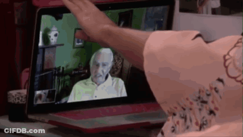 Woman Waving At Older Man On Screen GIF