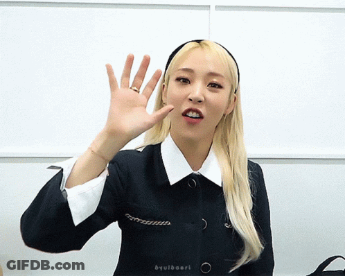 Woman Waving Hand In Headband And Black Jacket GIF