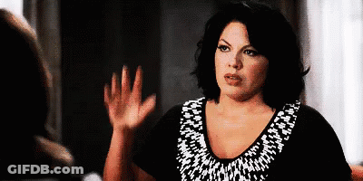 Woman Waving In Black And White Shirt GIF