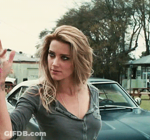 Woman Waving In Front Of Car GIF