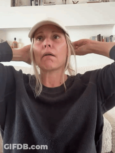 Woman Wearing Baseball Cap And Sweater GIF