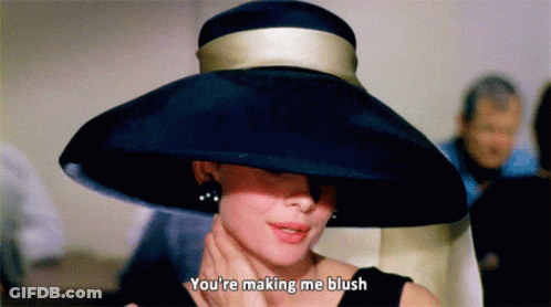 Woman Wearing Black Hat Says You're Making Me Blush GIF